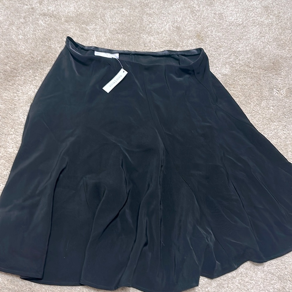 Size 8 White House Black Market black skirt never been worn still has tag on it.